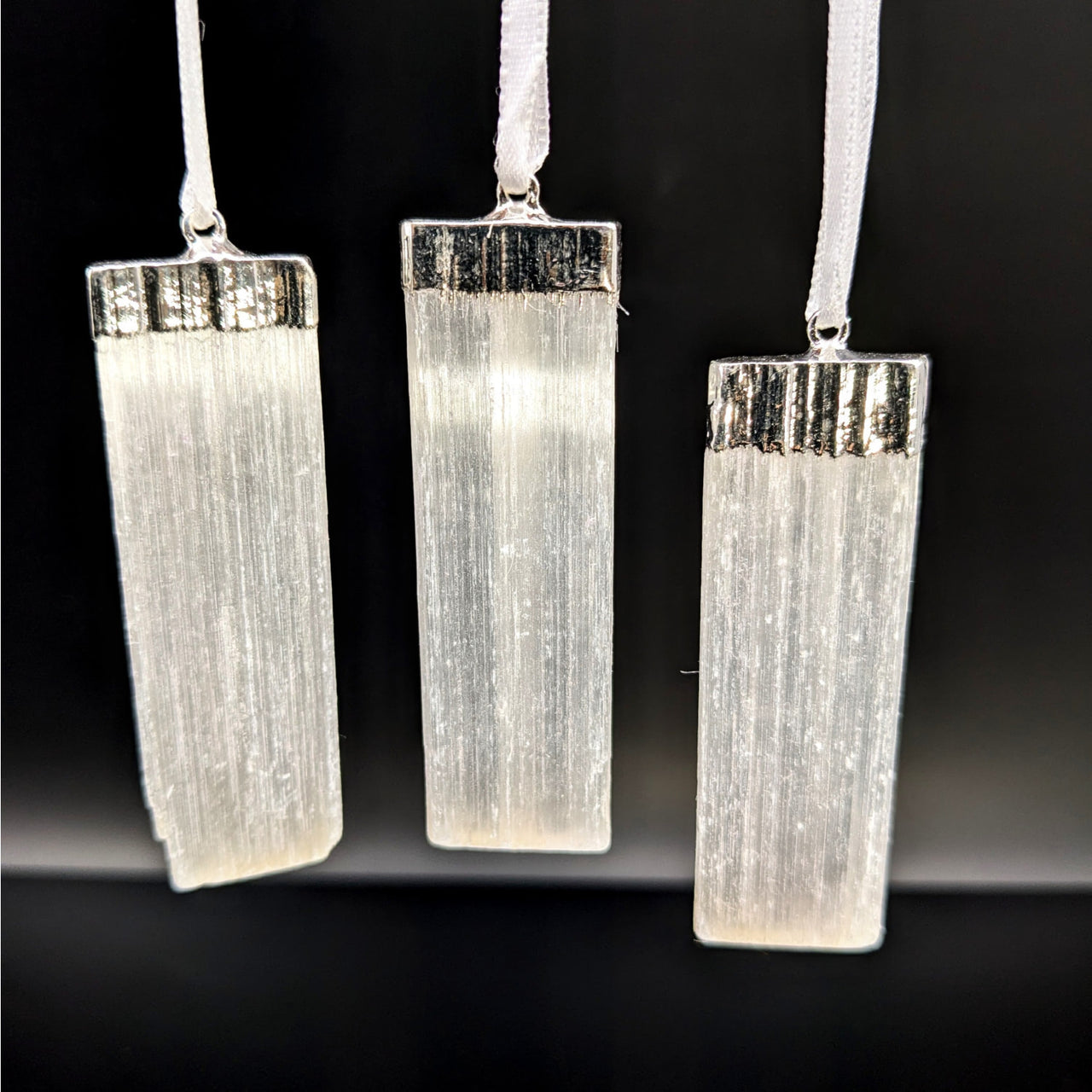 Three translucent Selenite crystal pendants on white ribbons for Selenite Bar Ornament