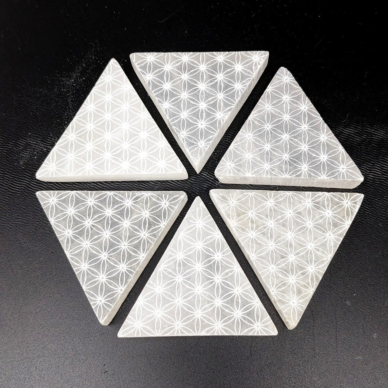 White and black geometric tile with flower pattern on Selenite Flower of Life 2.2’ Mini Plate