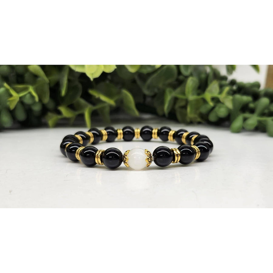 Black onyx and gold beaded bracelet with white moonstone accent, 8mm, 7.5 inches