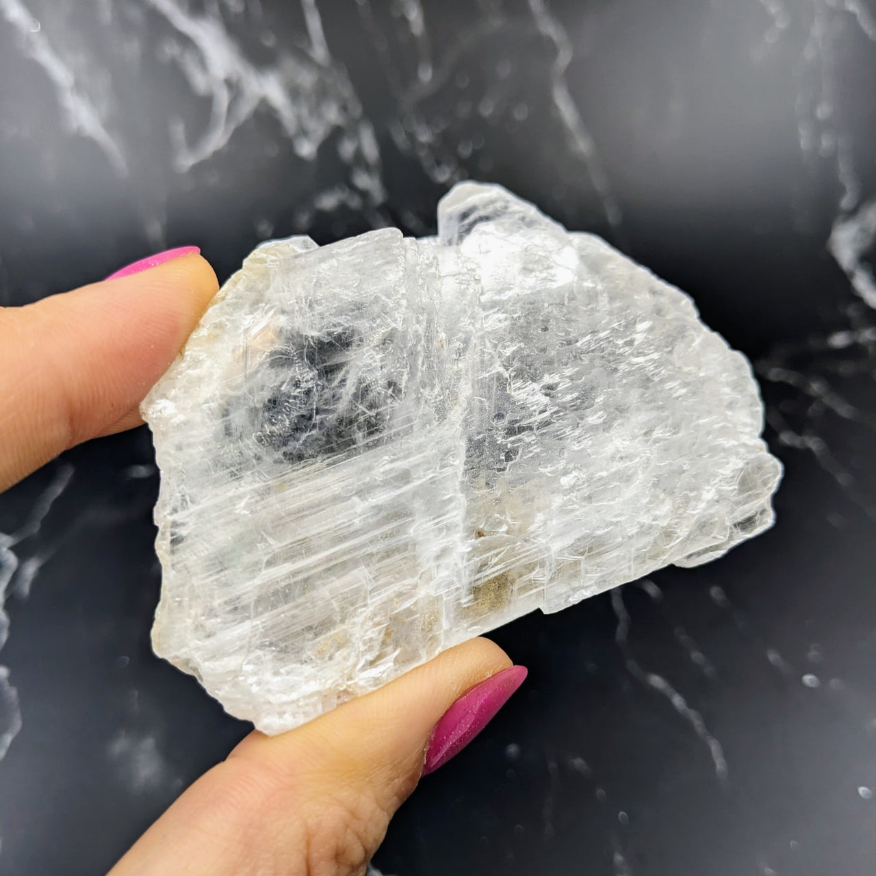 Close-up of a person holding Selenite Ice Slab Specimen for feng shui (#SK8199)