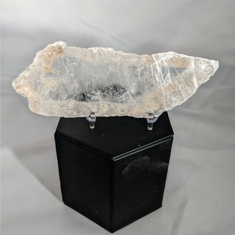 Translucent mica sheet on black display stand in Selenite Ice Slab Utah product shot