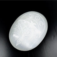 Luminous white Selenite palm stone engraved with moth and moon phases, 3-inch size