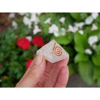 Selenite orgonite pyramid 1.2 inch clear quartz with copper spiral held gently between fingers for energy healing