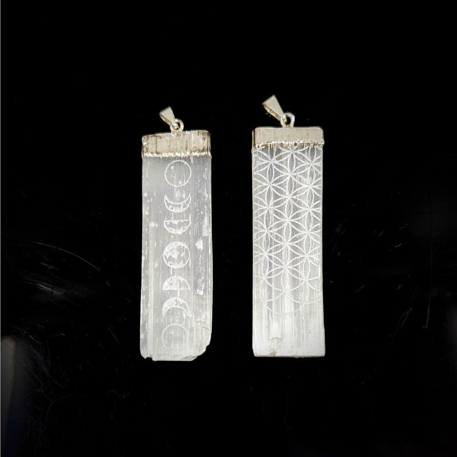 White crystal pendants with etched moon phases and Flower of Life pattern on silver bails