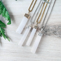 Three white selenite crystal pendants with gold and silver caps on box chains, LV9192