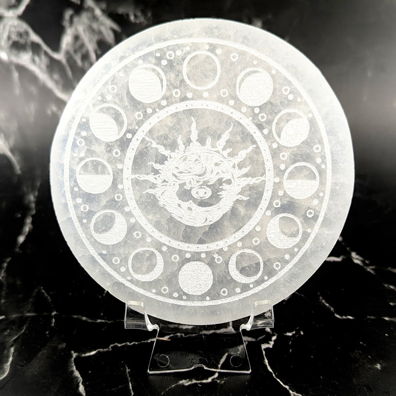 Translucent 4’’ selenite round plate with etched dragon and moon phases