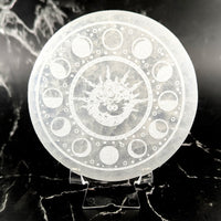 Translucent 4’’ selenite round plate with etched dragon and moon phases
