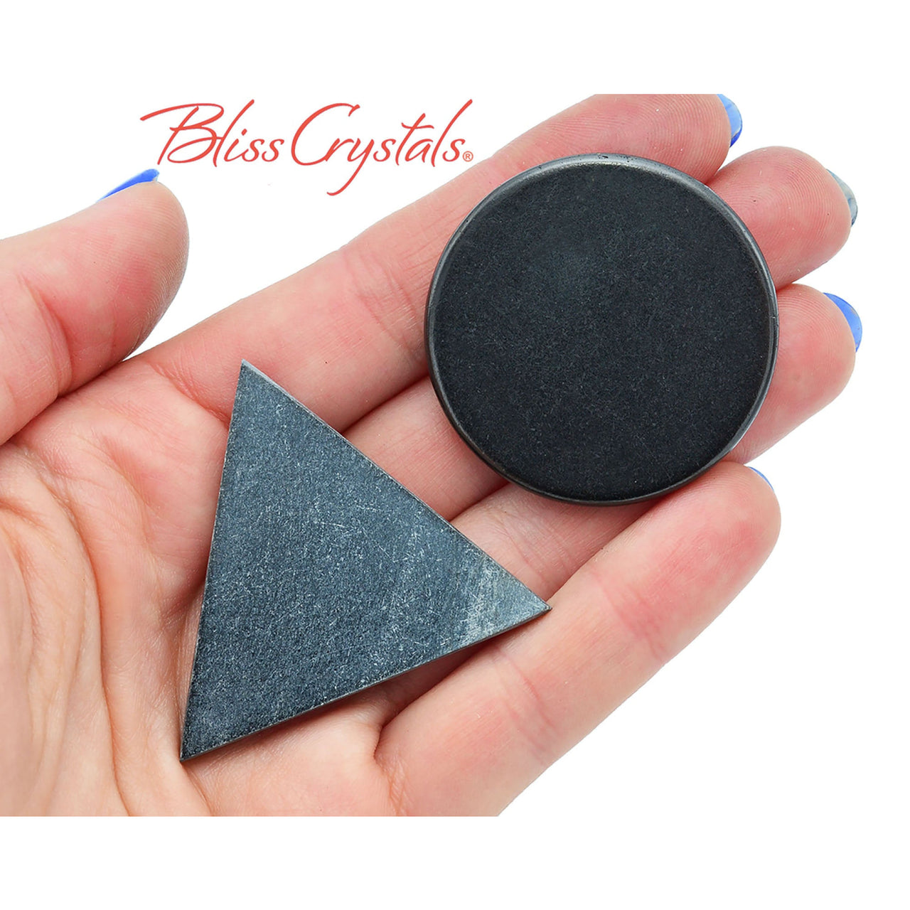 Hand holding shungite pocket stones for bioenergetic balancing and healing