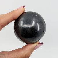 Thumbnail for Hand holding Shungite 1.9’ Sphere (140g) - Black Marble Ball #SK9328 for Healing and Meditation