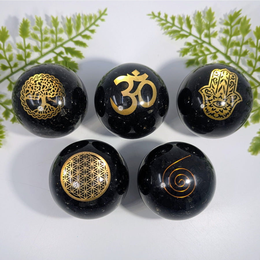 Black polished shungite orgonite sphere 2.13 inches engraved with golden symbols for crystals and jewelry use