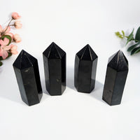 Four black obsidian crystal points on a Shungite 3-inch Tower product display