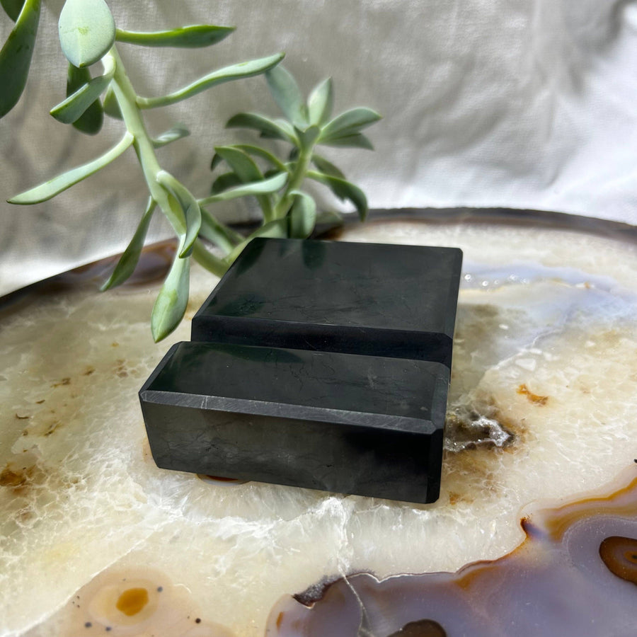 Dark rectangular Shungite cellphone holder displaying a stylish and durable phone stand