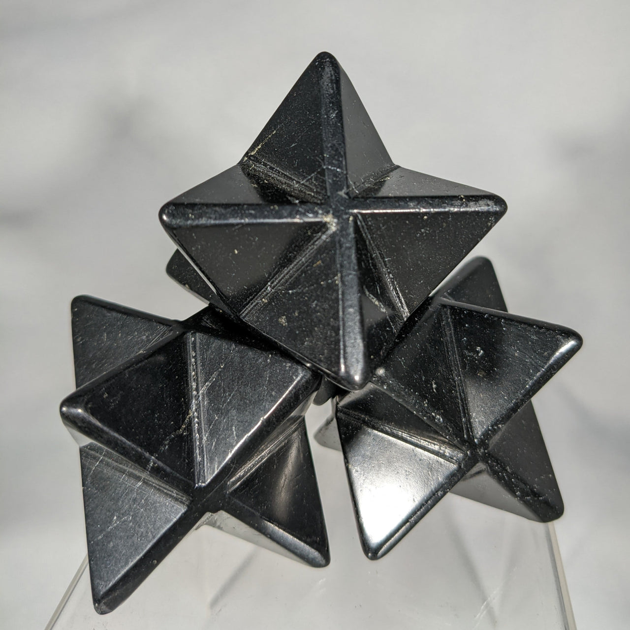 Stacked black star-shaped polyhedra in the Shungite Merkaba C084 product