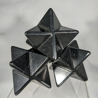 Stacked black star-shaped polyhedra in the Shungite Merkaba C084 product