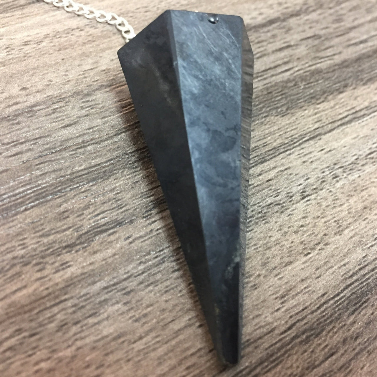 Dark faceted stone pendant from Shungite Pendulum J107 product display