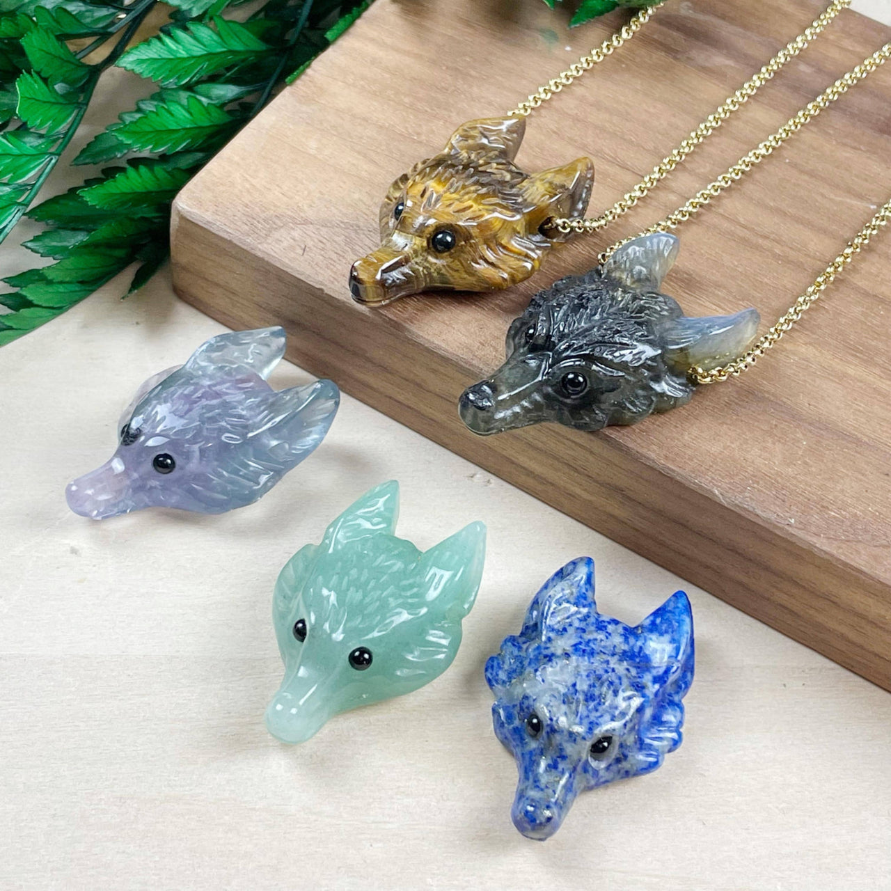 Small carved gemstone wolf head pendants in amber, gray, lavender, mint, blue