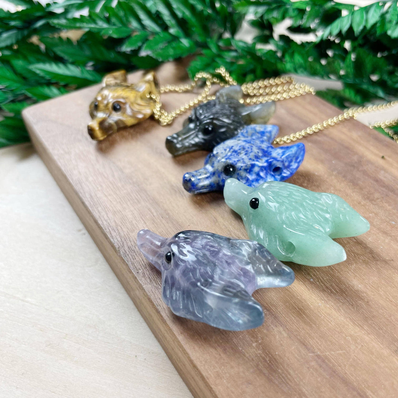 Set of 5 hand-carved wolf pendants in gemstone colors