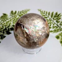 Smoky quartz 2.5 inch polished sphere BC1031 with iridescent inclusions