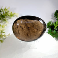 Smoky quartz 2.6 jumbo palm stone with polished oval shape rich brown hue and natural golden inclusions