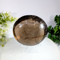 Smoky quartz 2.7 inch jumbo palm stone with polished translucent earthy brown hue and internal crystalline inclusions