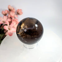 Polished 2-inch smoky quartz sphere with golden inclusions #BC0657