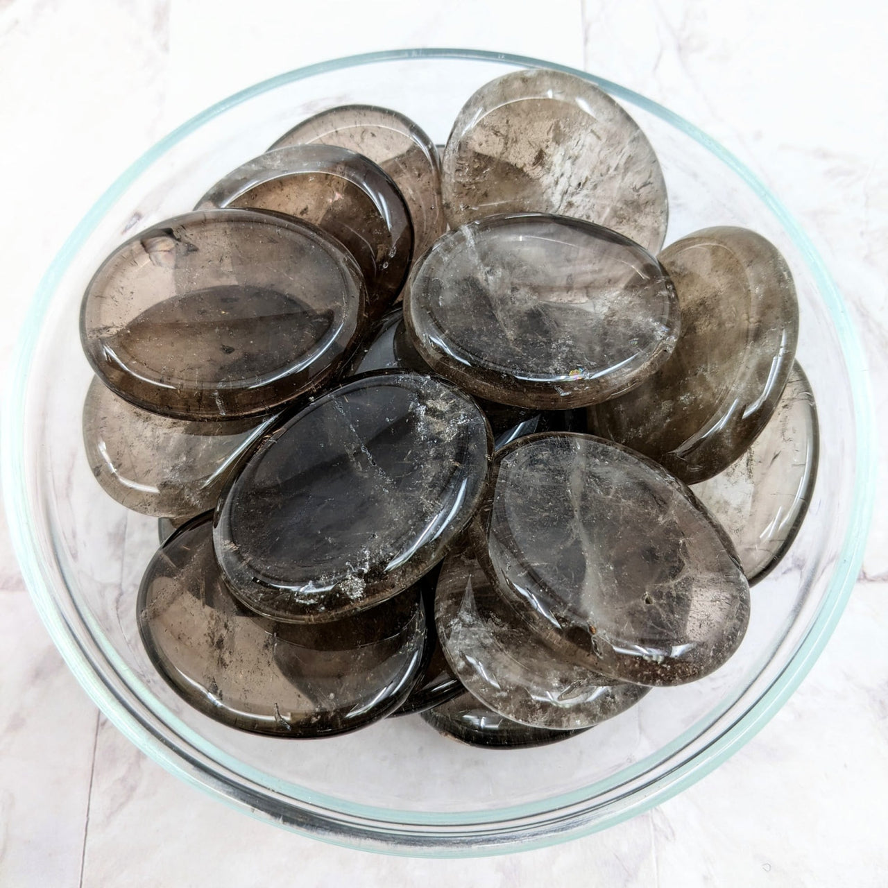 Smoky Quartz Thumb Stone LV2265 resting in a bowl filled with ice and ice crystals