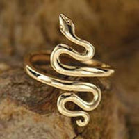 Thumbnail for Gold snake ring displayed on a rock, available as Snake Bronze Adj. Ring #J023