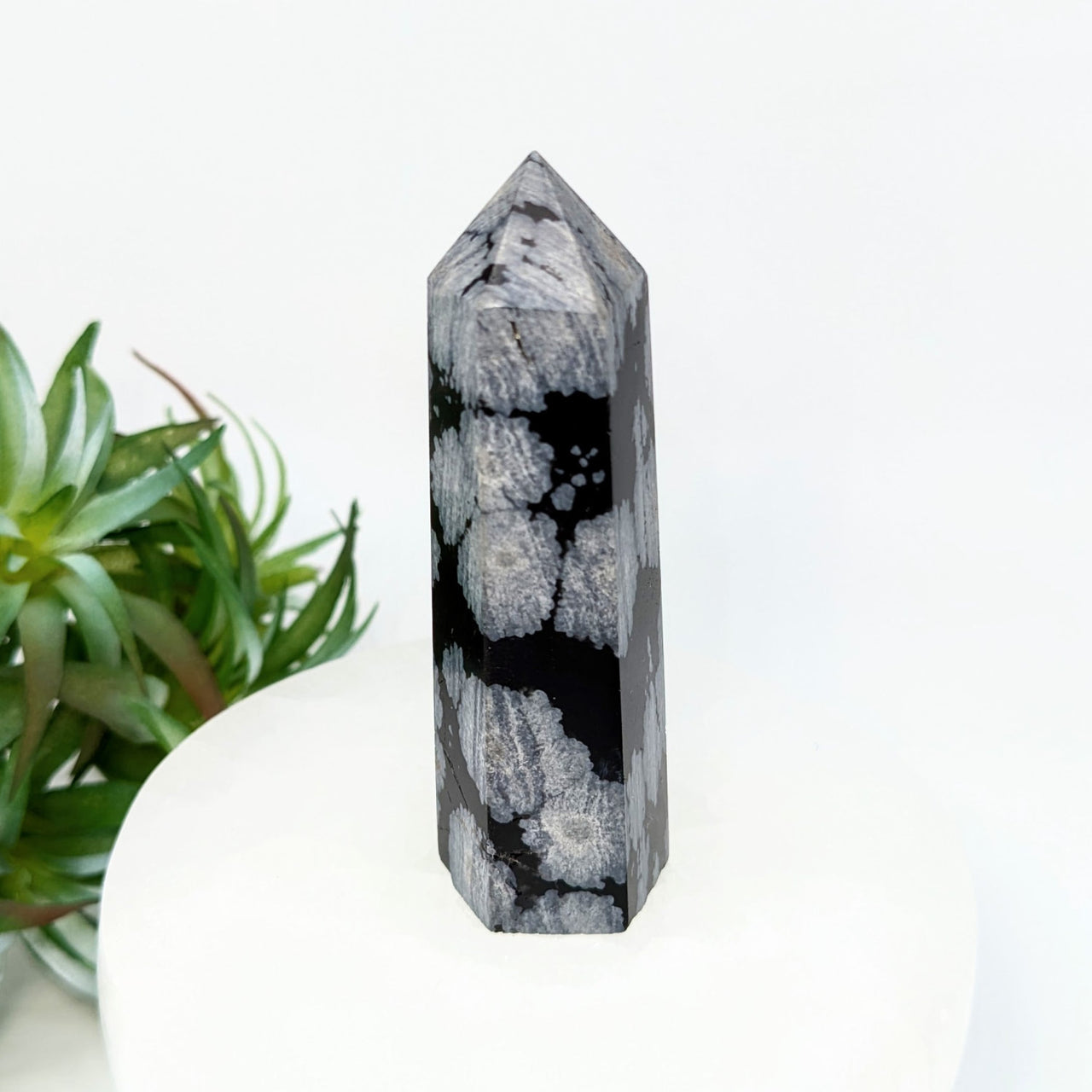 Black and grey Snowflake Obsidian crystalline obelisk tower with mottled patterns