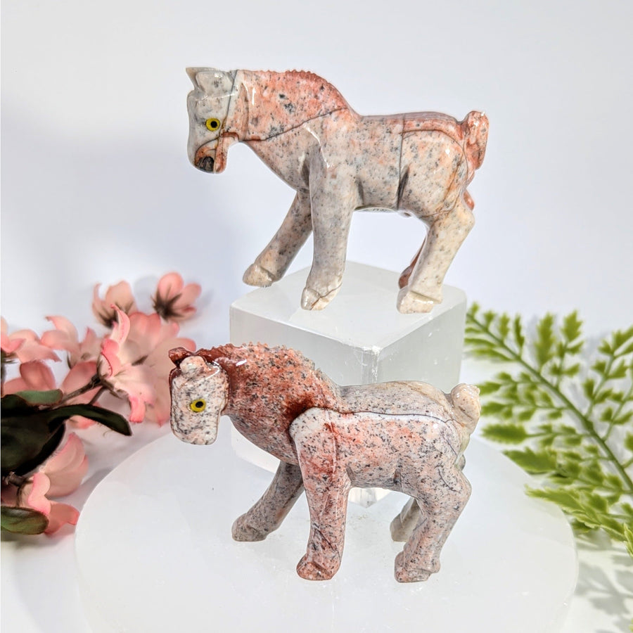 Two 3-inch soapstone horse carvings BC0783 on pedestal, speckled pinkish-gray