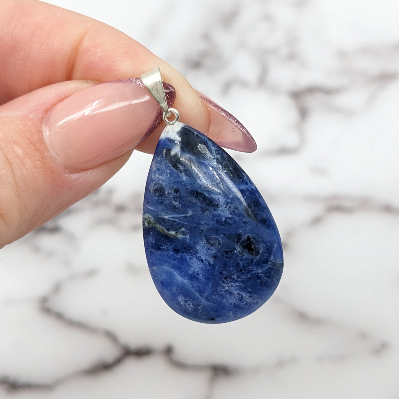 Blue Sodalite 1’ Teardrop Pendant with Silver Ring #SK9869 held in hand