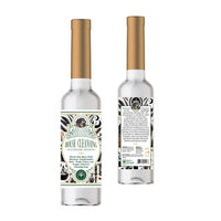 Clear glass bottle with gold cap and ornate black and white label for soul sticks house cleansing water spiritual product