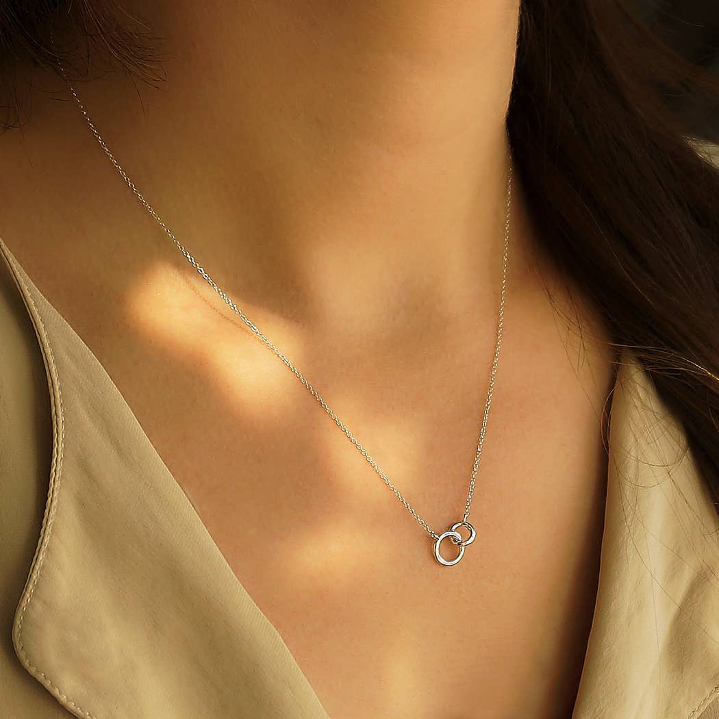 Woman wearing a Sterling Silver Linked Circles Necklace, product #J043