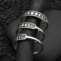 Sterling silver moon phase rings set on wooden stick LV9573