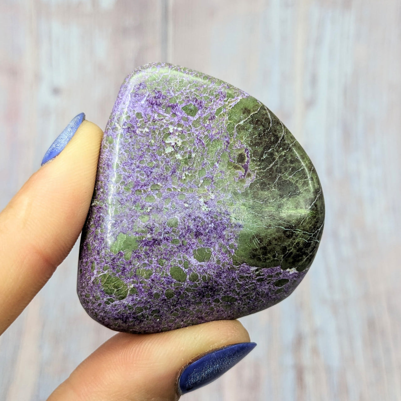 Person holding a large purple and green Stitchtite Serpentine 1.9’ Pebble #SK9968