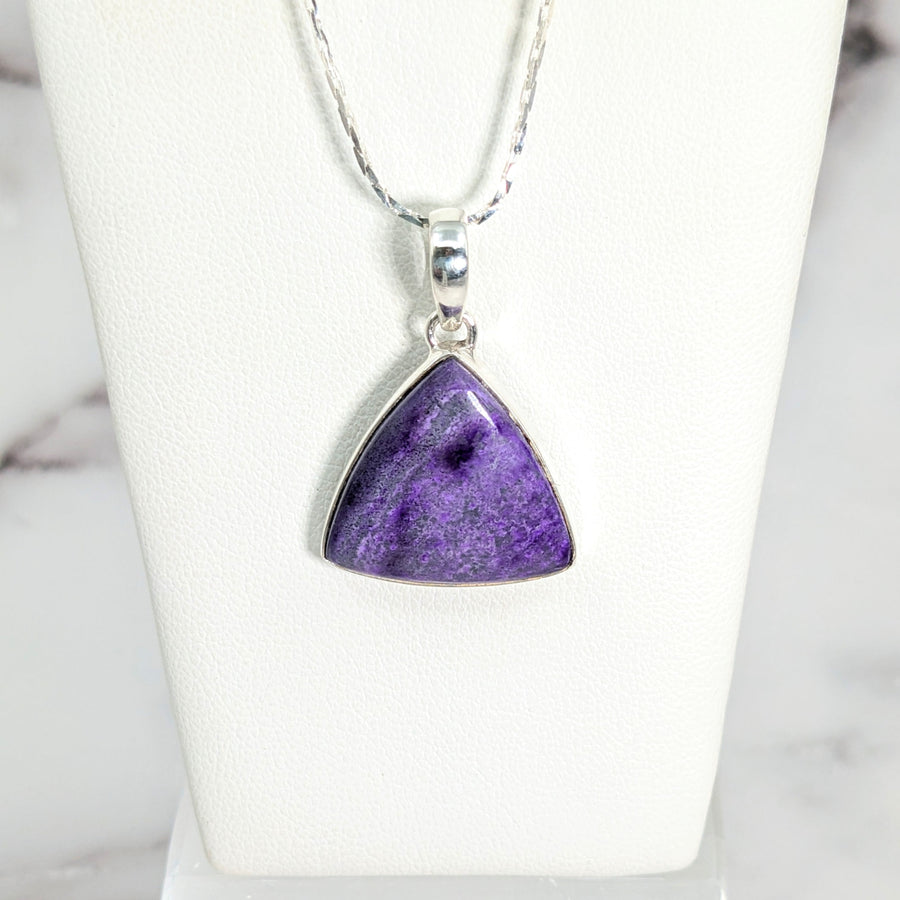 Sugilite 0.75’ triangle pendant #LV2645 on a silver chain featuring a purple stone