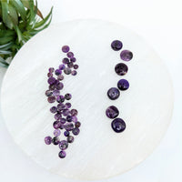 Thumbnail for Purple Sugilite Rondelle Beads arranged vertically on a white surface