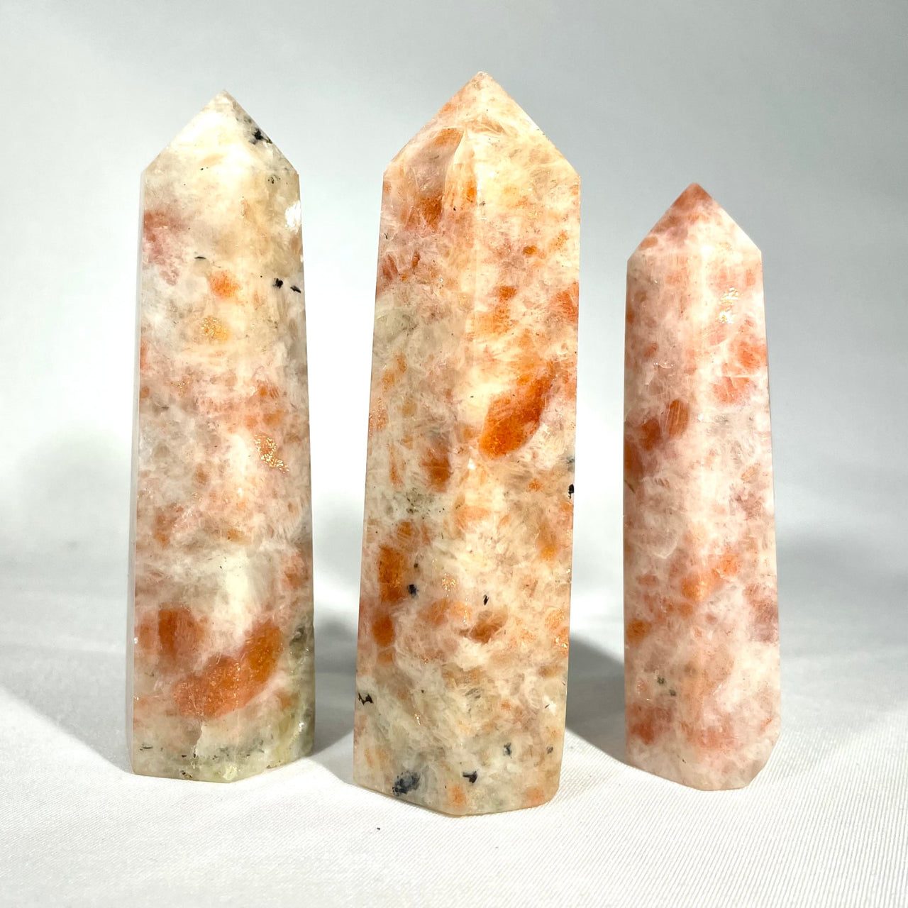Three polished Sunstone 3-3.5’’ tower crystals with orange and white marbling