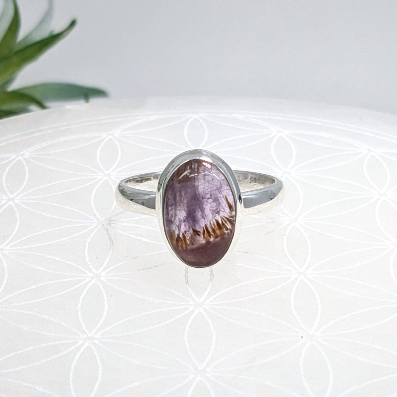 Silver oval ring with a purple-brown gemstone in a simple band design, Super 7 Sz 8.75