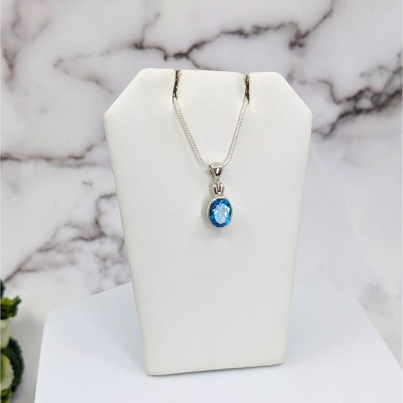 Swiss Blue Topaz Faceted Sterling Silver Pendant #LV3326 on a white necklace