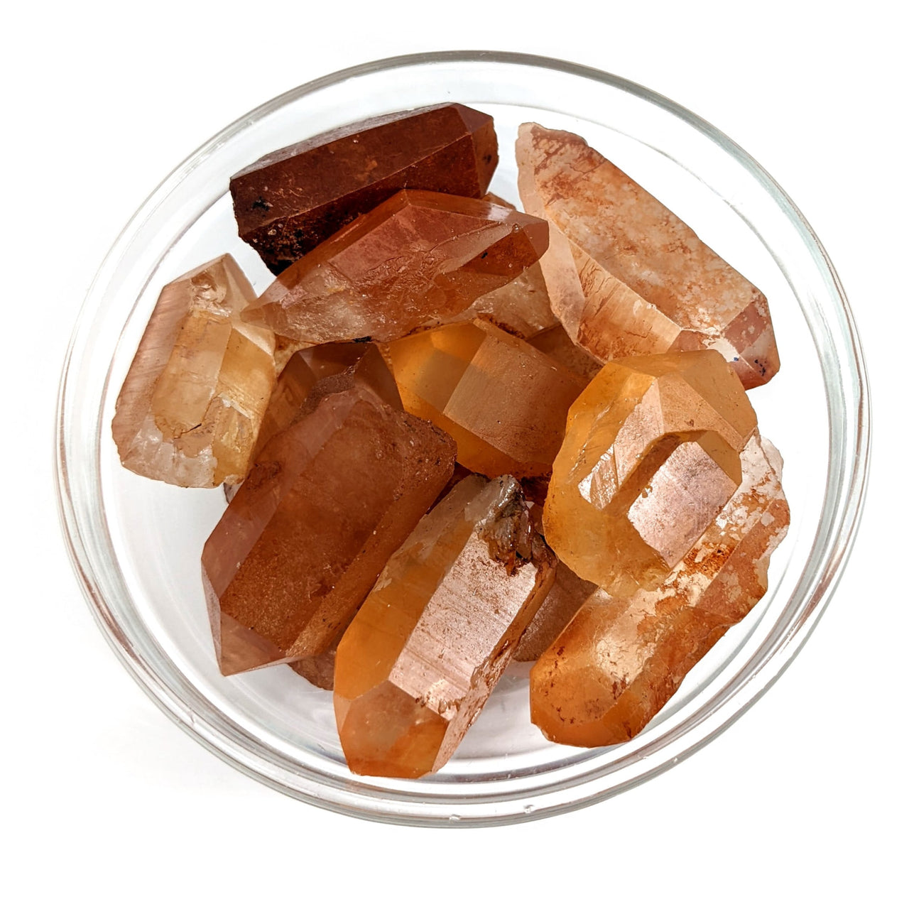 A vibrant bowl of assorted colored crystals featuring Tangerine Quartz Natural Point #SK9252