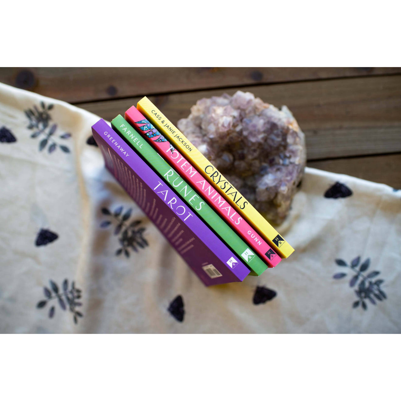 Colorful books and a crystal beside Tarot: A Simple Guide to Major & Minor Arcana