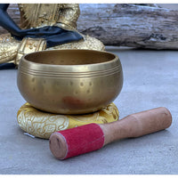 Golden singing bowl with mallet from Tibetan Brass Gong Meditation Singing Bowl Set
