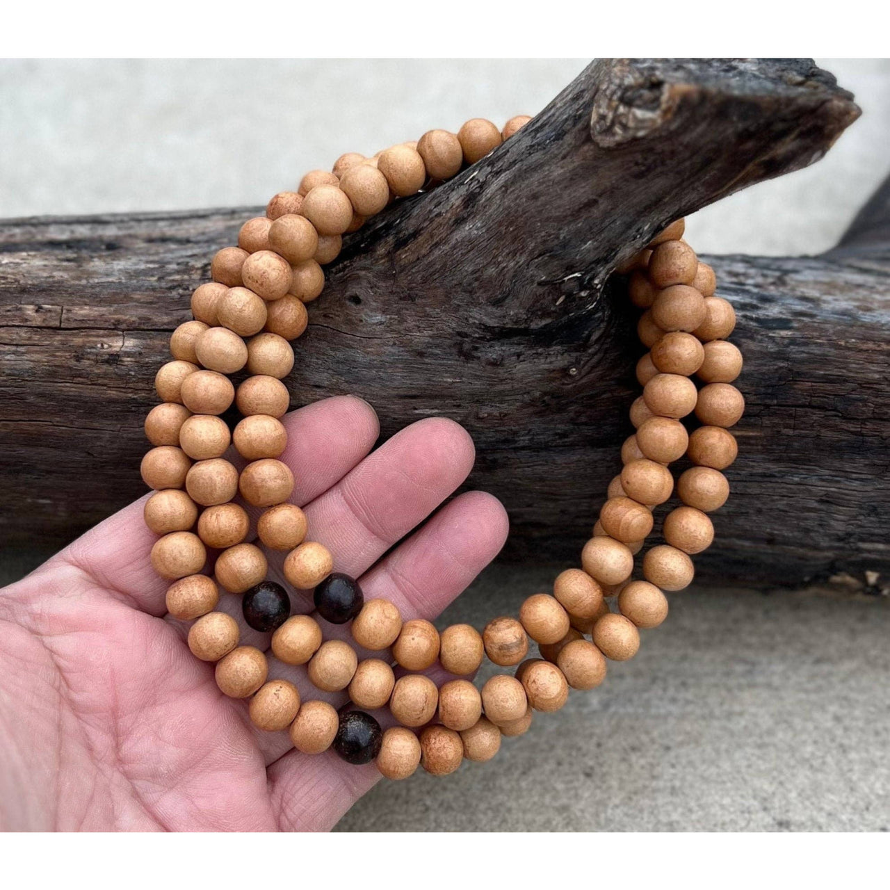 Wooden beaded mala necklace with sandal wood beads and silk pouch display