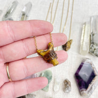 Golden tiger head pendant necklace with polished amber-brown stone finish