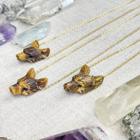Three tiger eye carved wolf head necklaces on gold chains