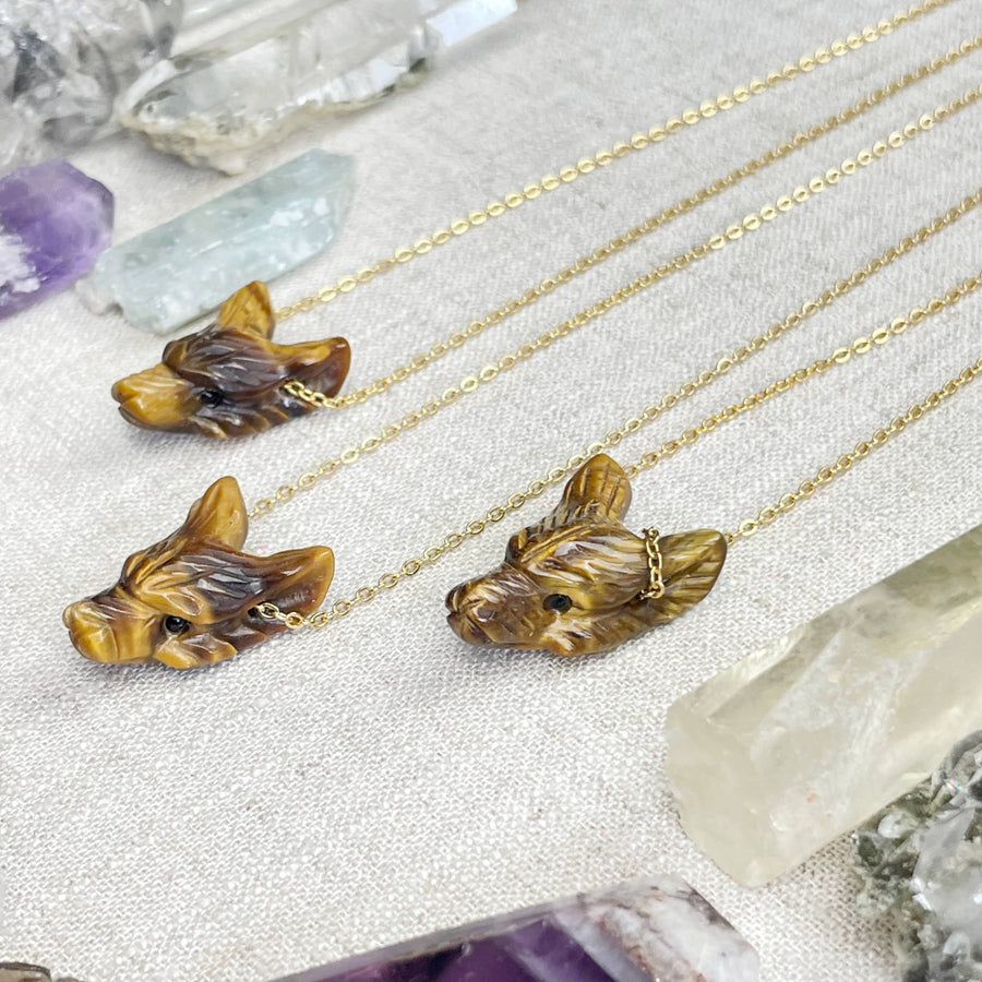 Three tiger eye carved wolf head necklaces on gold chains
