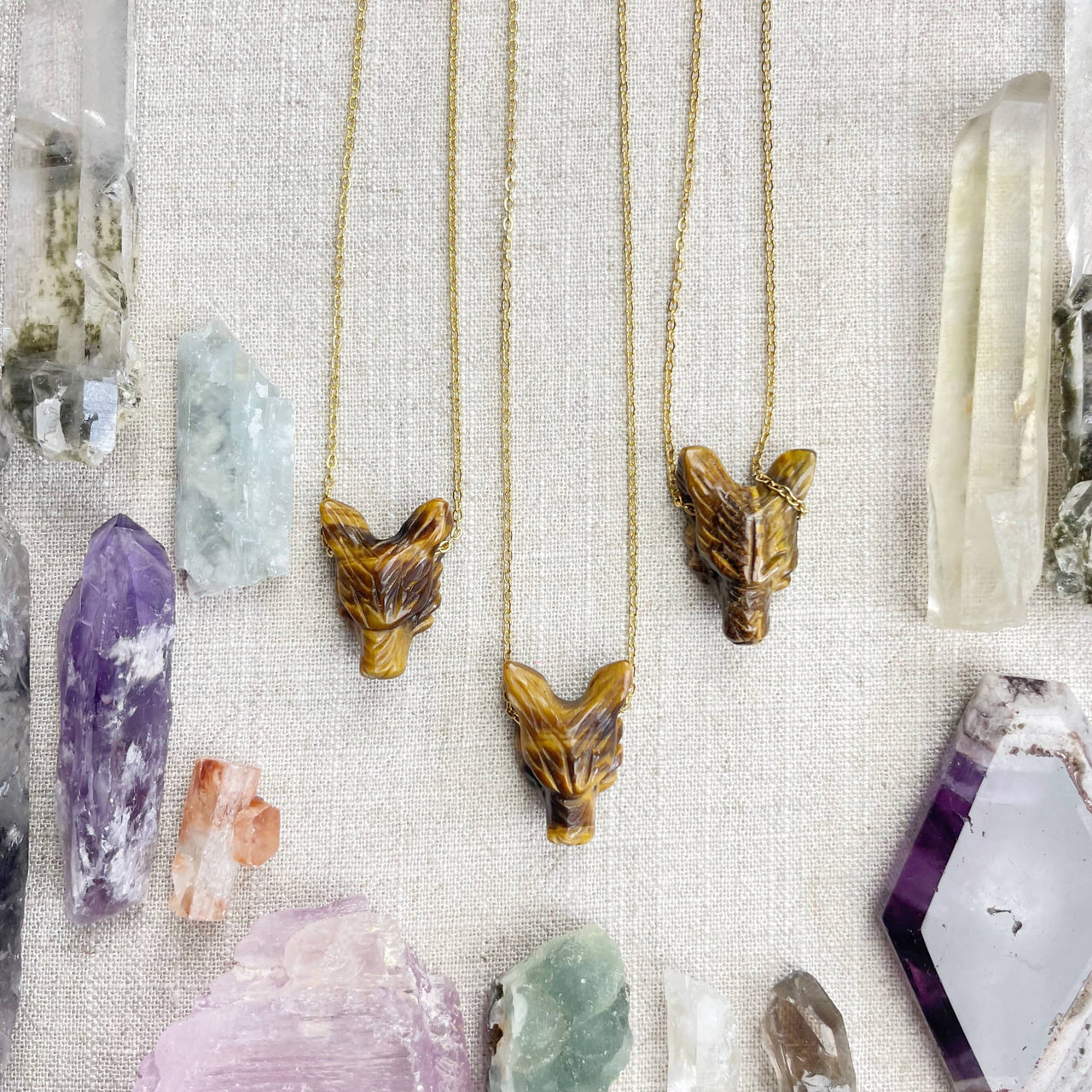 Three tiger eye fox head necklaces with polished amber-gold carvings