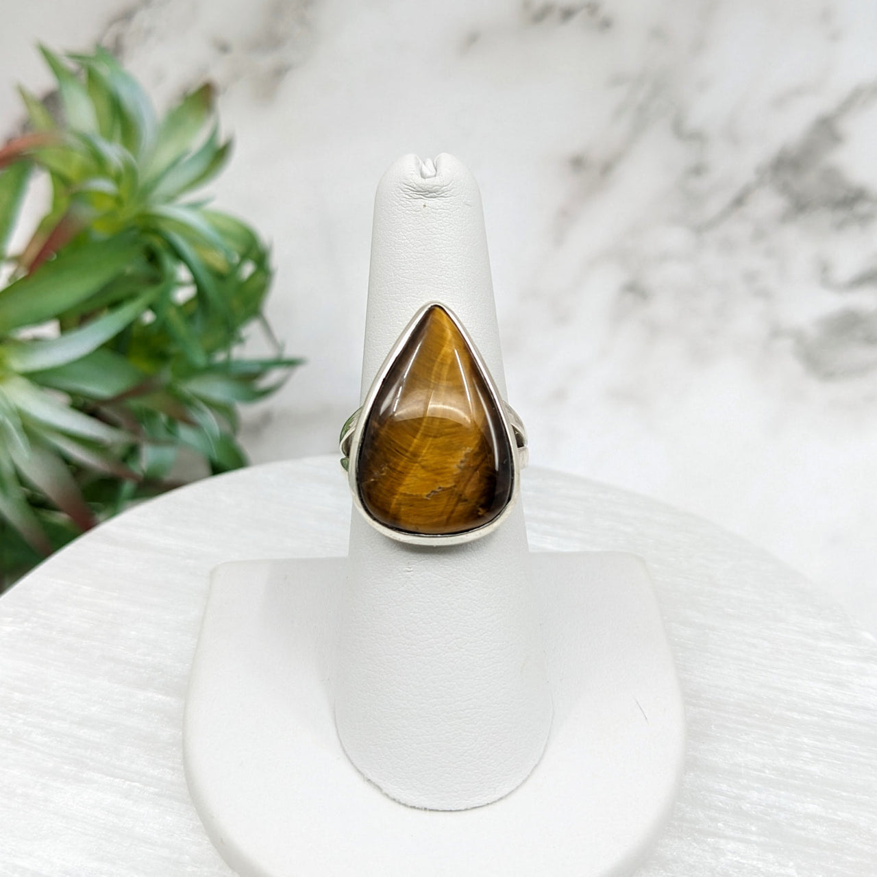 Tiger’s Eye Sz 7 Teardrop Ring LV5104 with yellow tiger eye stone on white stand