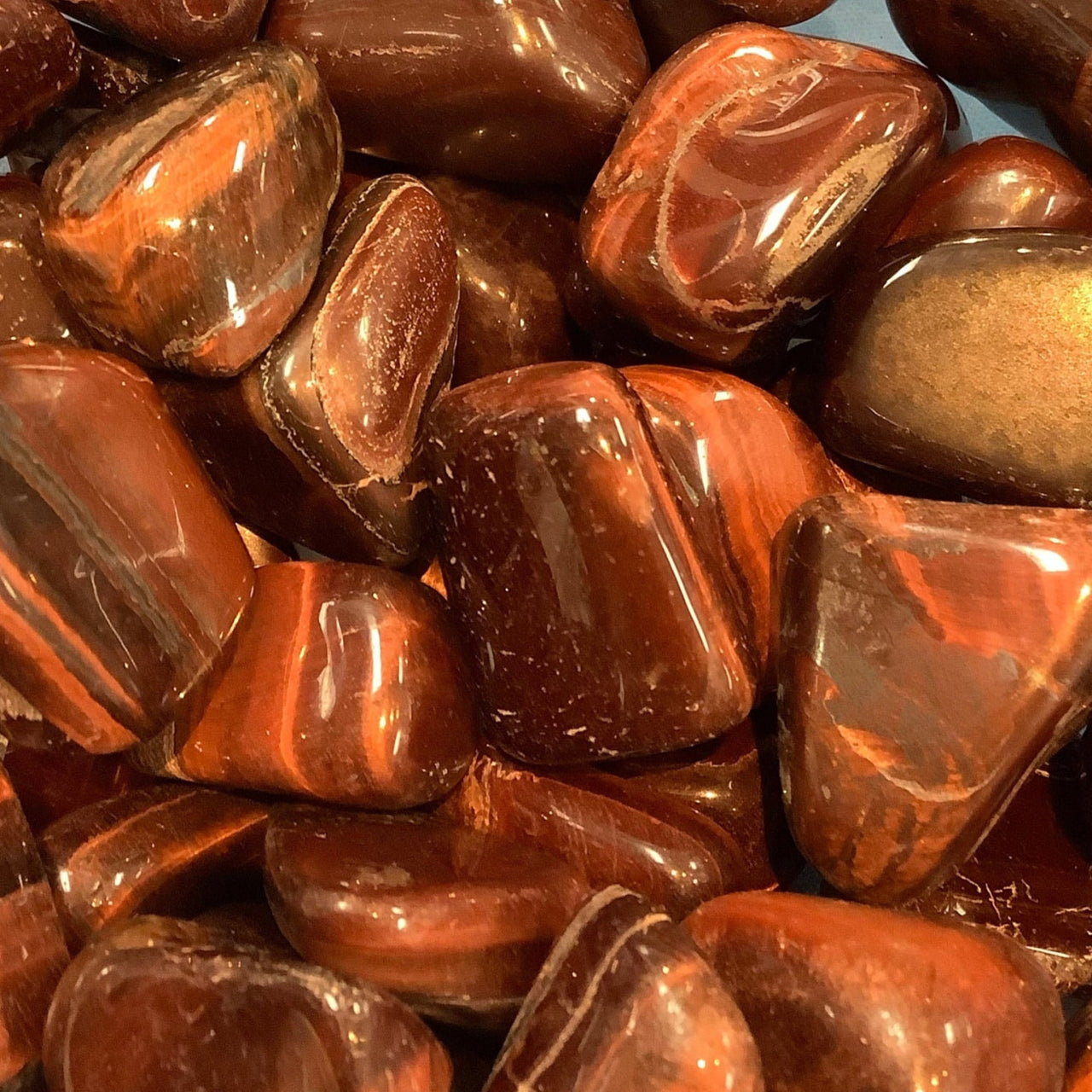 Polished red jasper stones with brown striations in Tiger’s Eye Tumbled #T323