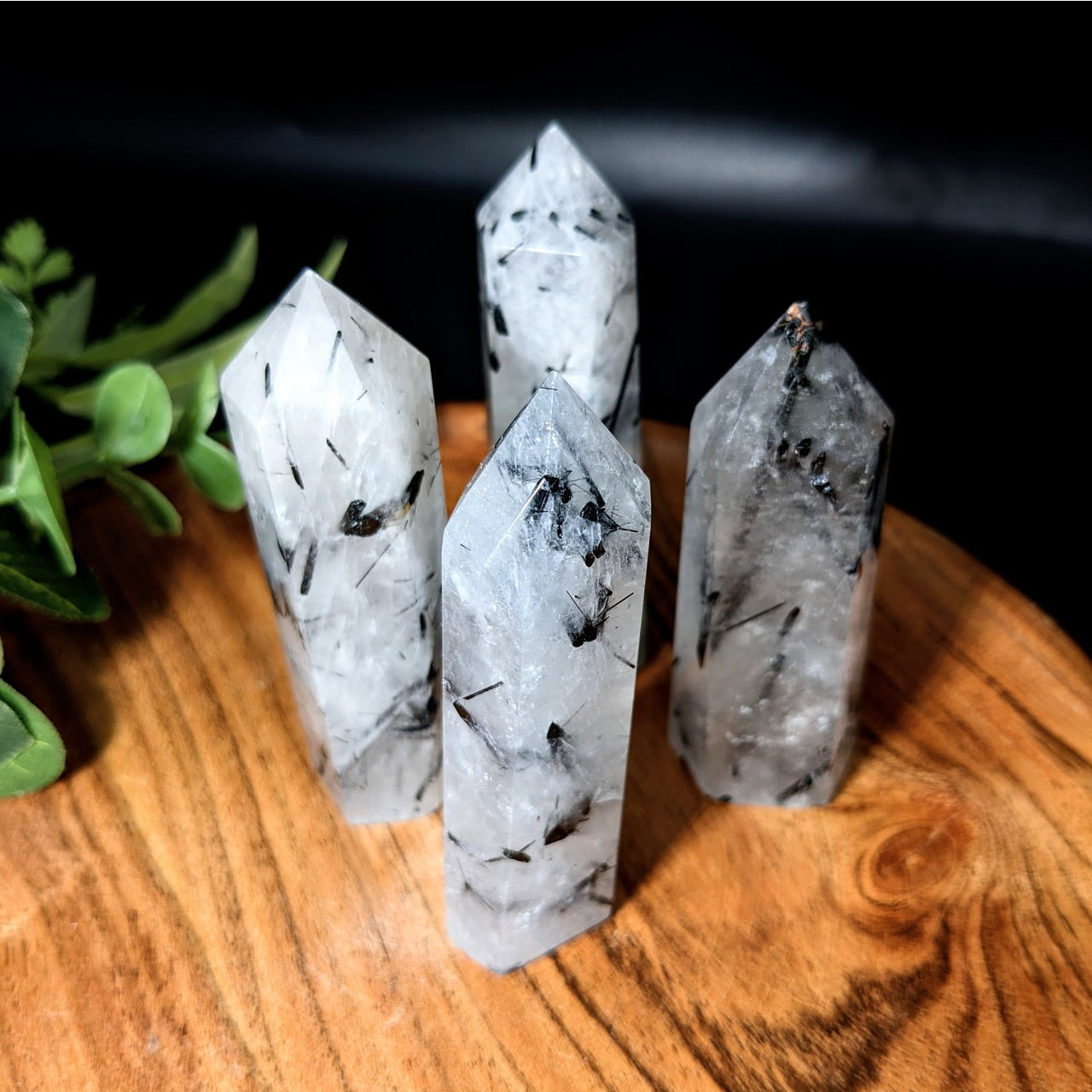 Tourmalinated Quartz Tower #LV2169: Three quartz crystals on a wooden table